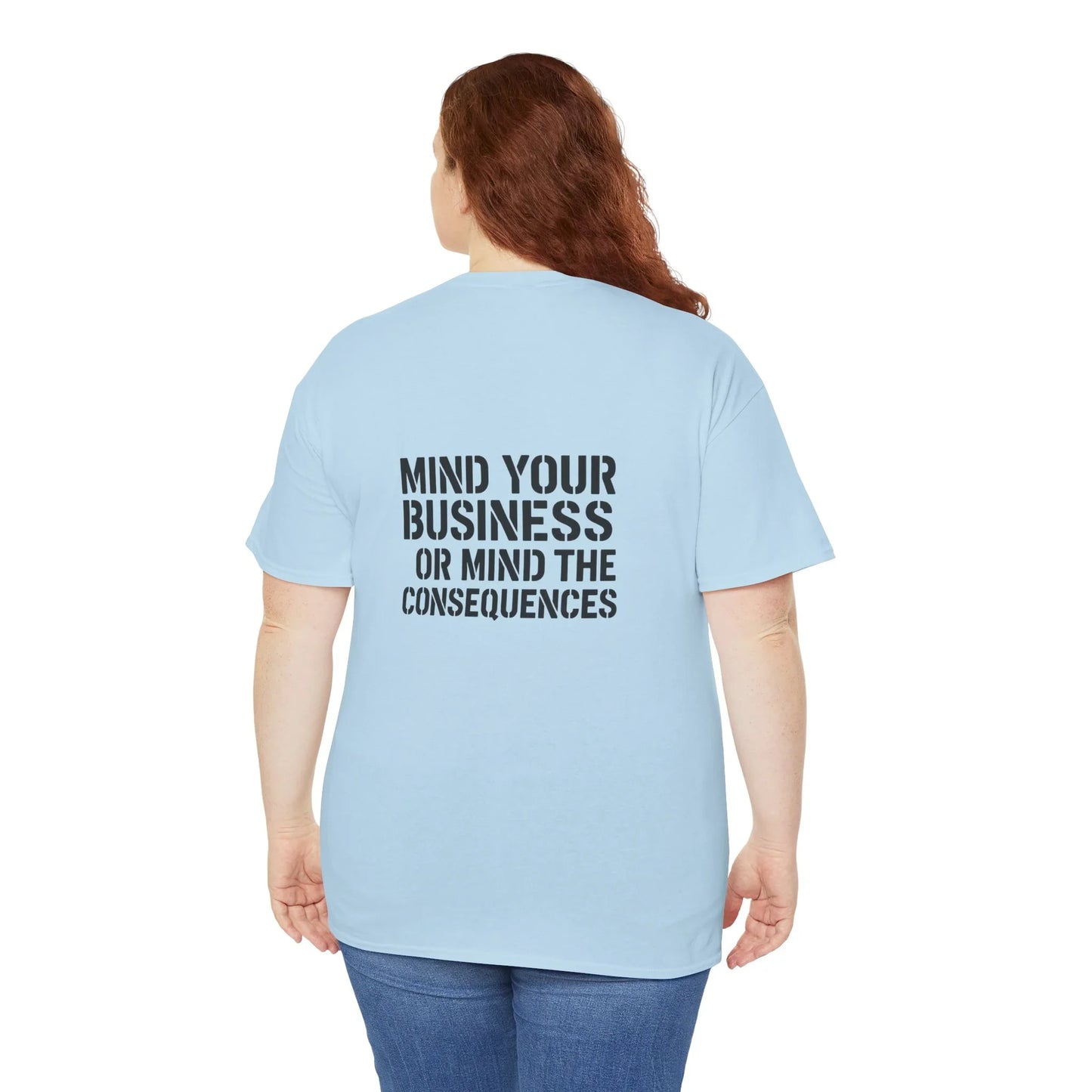 Woman in light blue t-shirt with 'Mind your business or mind the consequences' text on back