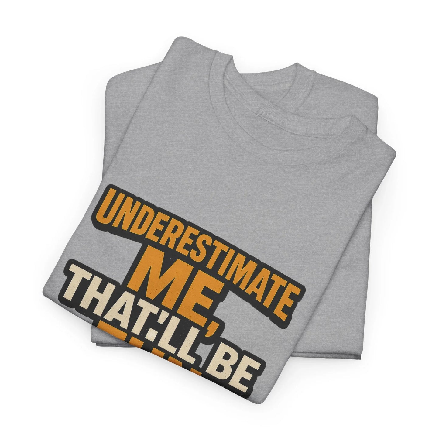 Folded gray T-shirt with bold 'Underestimate me' motivational quote in orange and white print