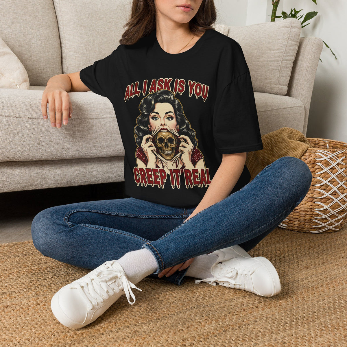 Seated model wearing the All I Ask Is You Creep It Real Halloween graphic tee in black