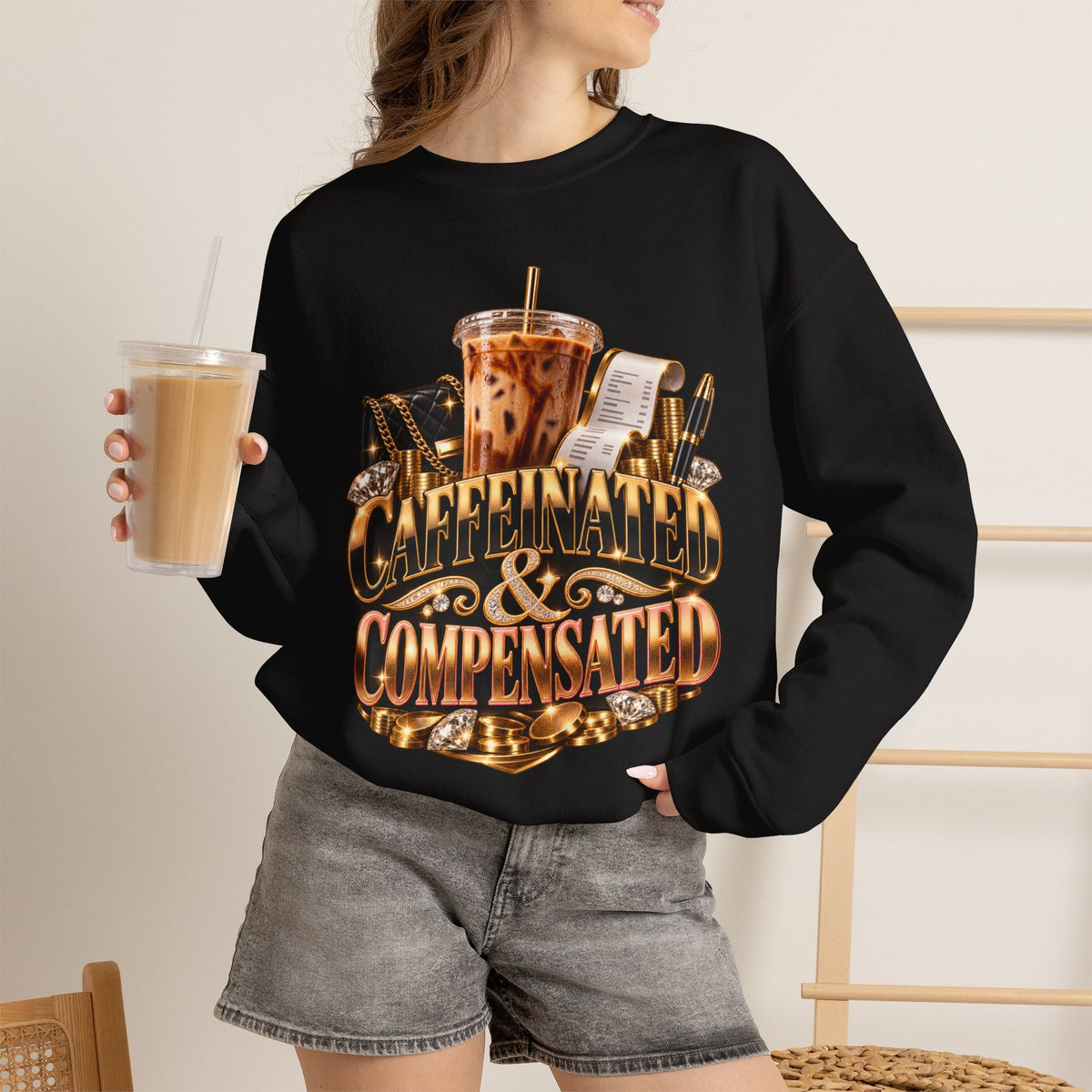Woman wearing the Caffeinated & Compensated black crewneck sweatshirt in a casual coffee-inspired setting
