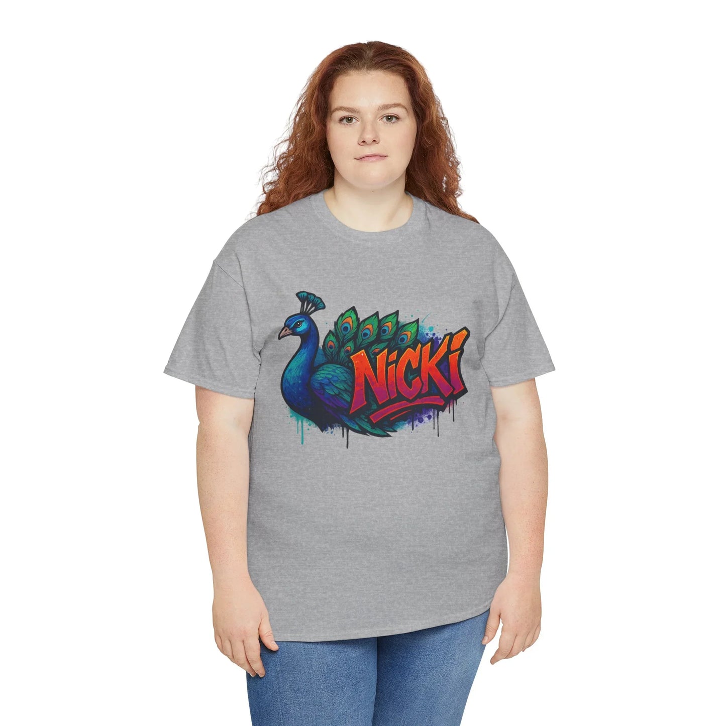 Woman wearing gray graphic tee with colorful peacock and Nicki graffiti text