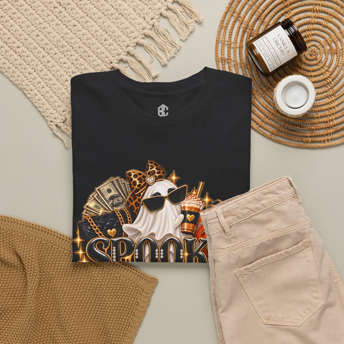 Spooky Rich in Training black graphic T-shirt styled on a table with accessories
