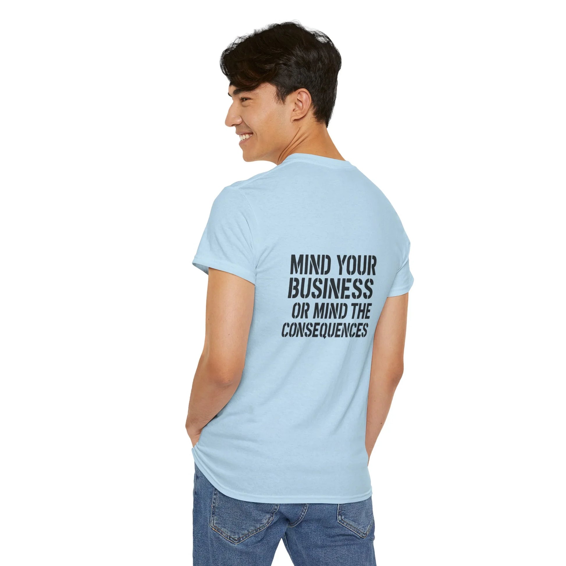 Man in light blue graphic t-shirt with 'Mind Your Business or Mind the Consequences' text