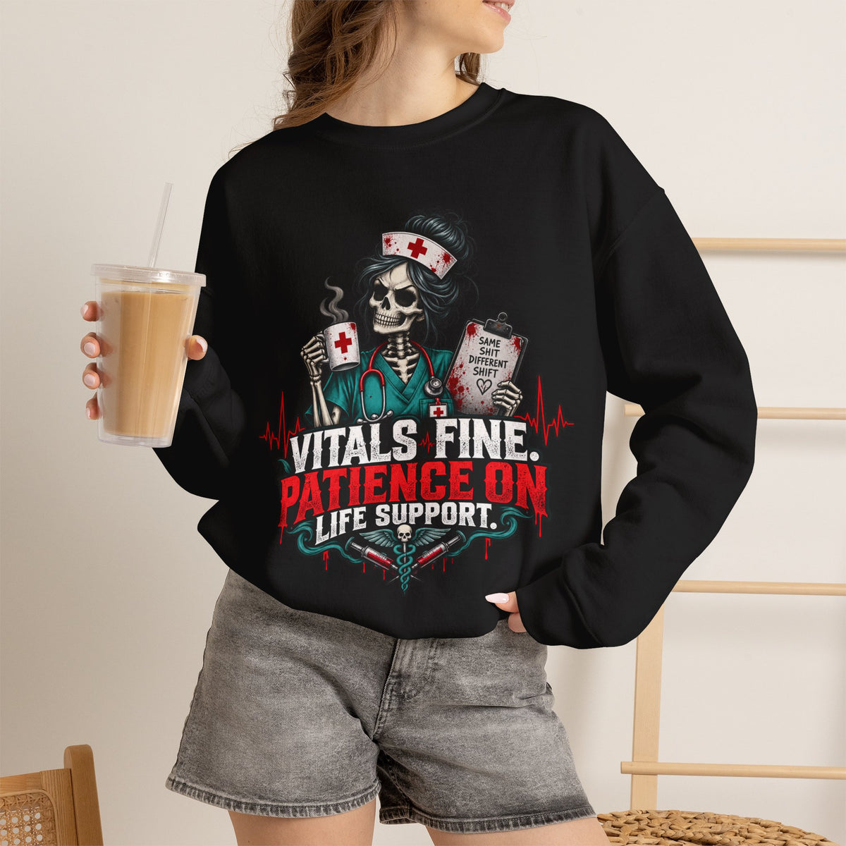 Model wearing black Vitals Fine Patience on Life Support nurse sweatshirt in lifestyle setting