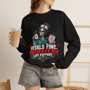 Model wearing black Vitals Fine Patience on Life Support nurse sweatshirt in lifestyle setting