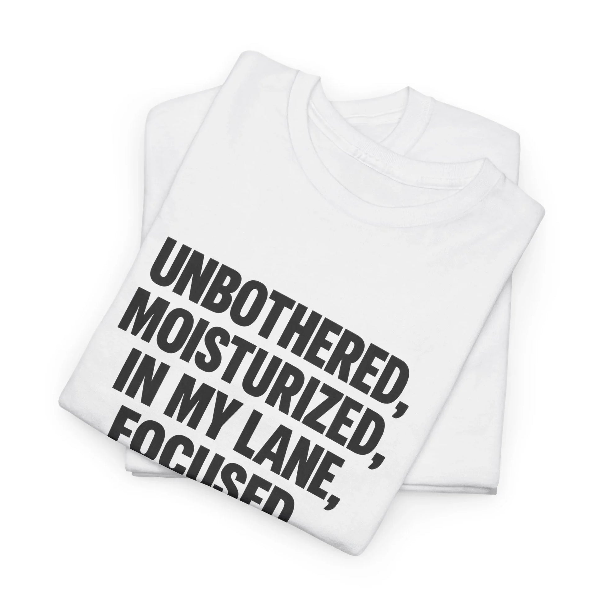 Folded white graphic t-shirt with bold black quote text: Unbothered, Moisturized, In My Lane, Focused.