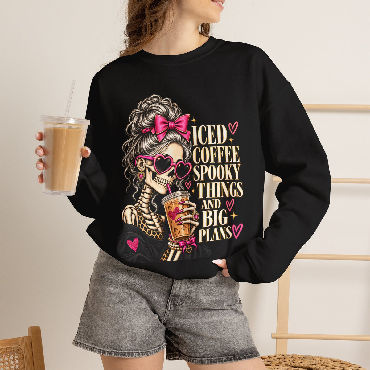 Woman wearing the Iced Coffee & Big Plans black crewneck sweatshirt in a casual fall setting