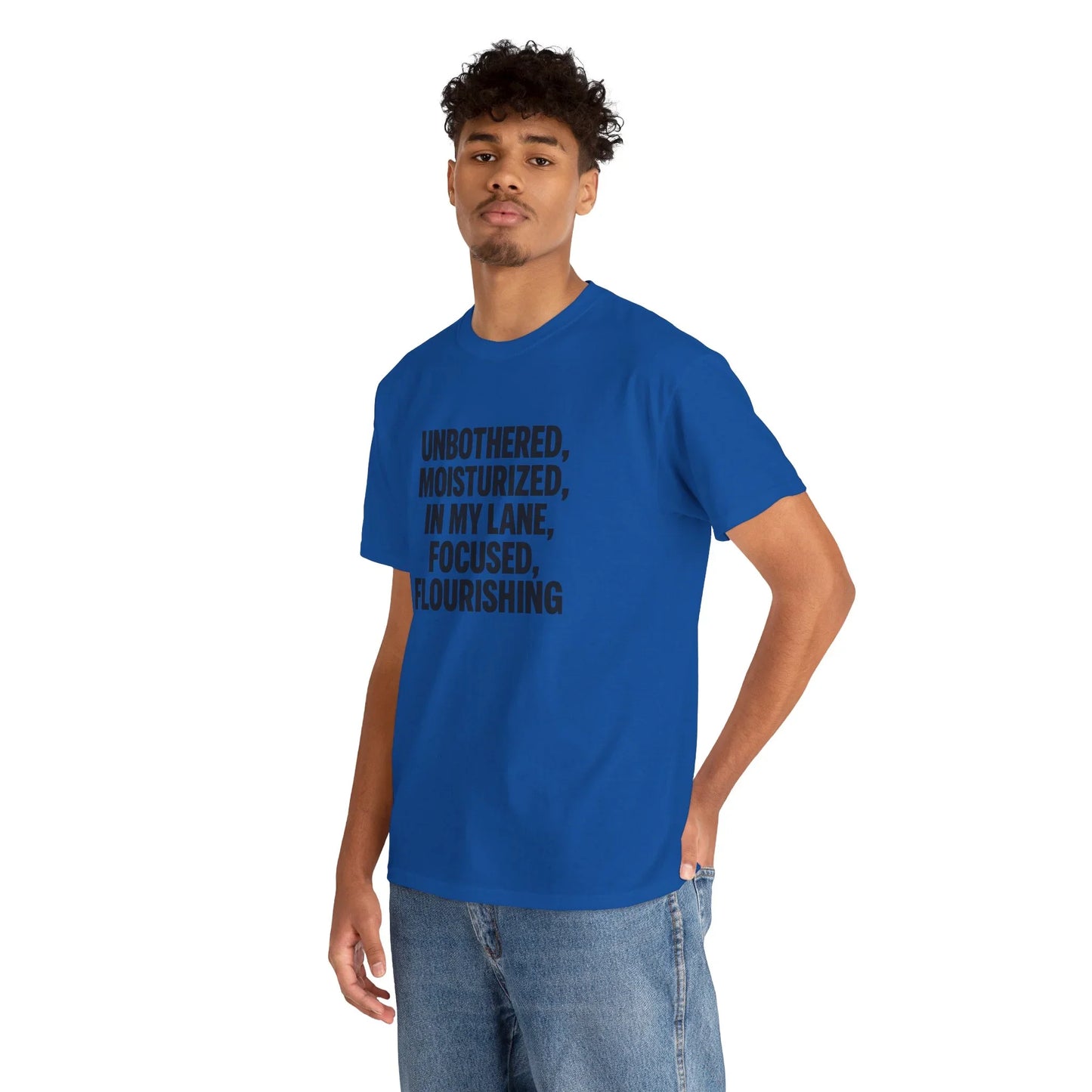 Man wearing blue graphic t-shirt with motivational quote, casual jeans, white background