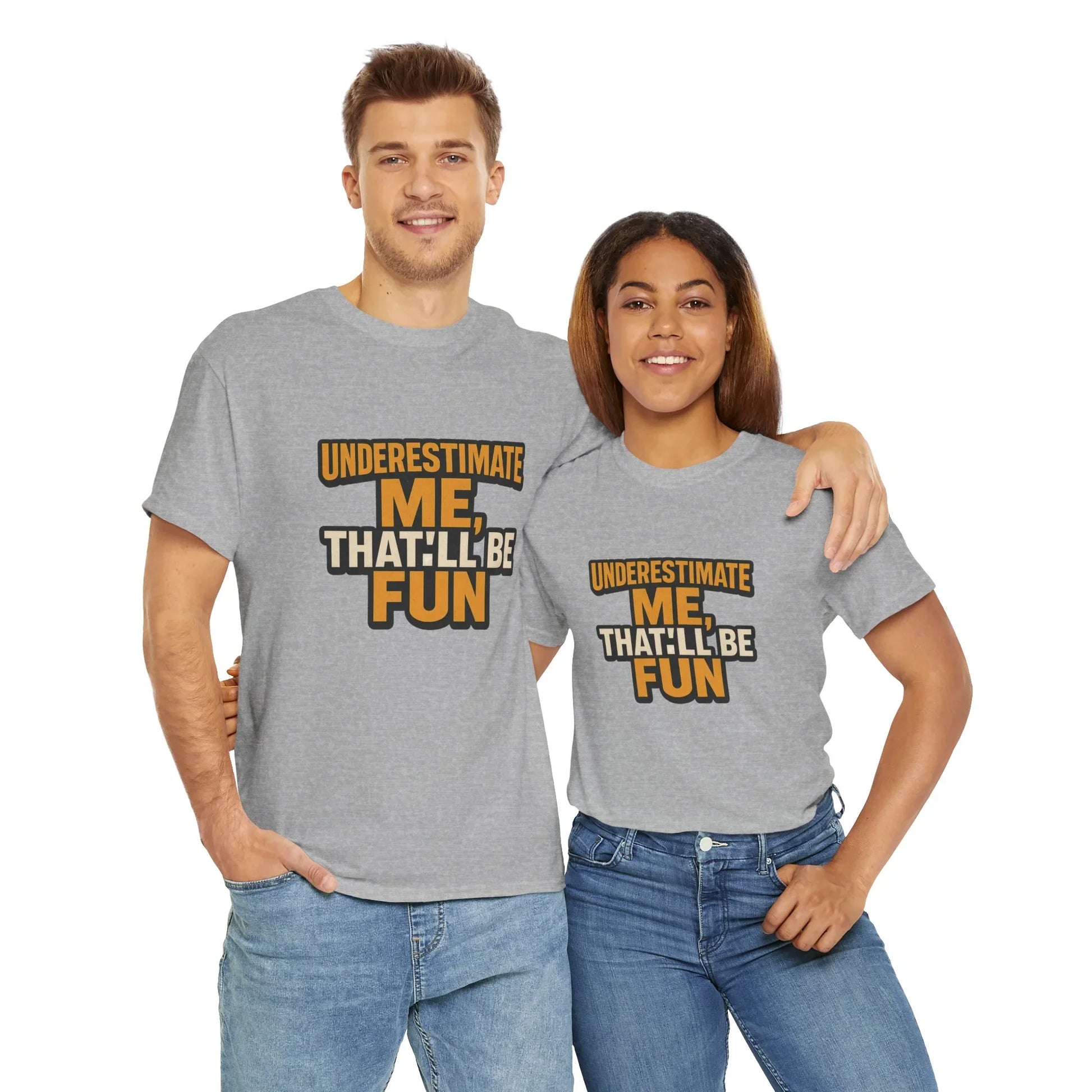Smiling couple in matching grey 'Underestimate Me That'll Be Fun' graphic t-shirts