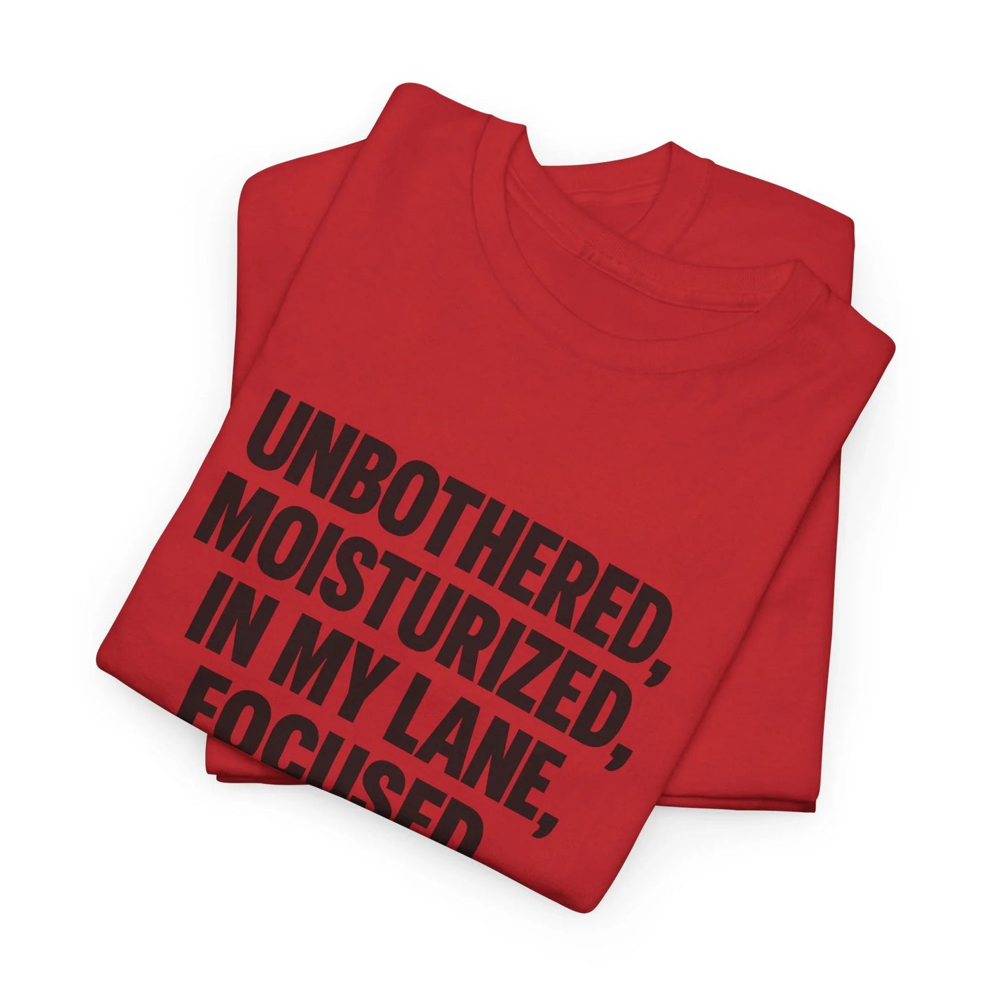 Folded red graphic t-shirt with bold black motivational text, minimalist flat lay