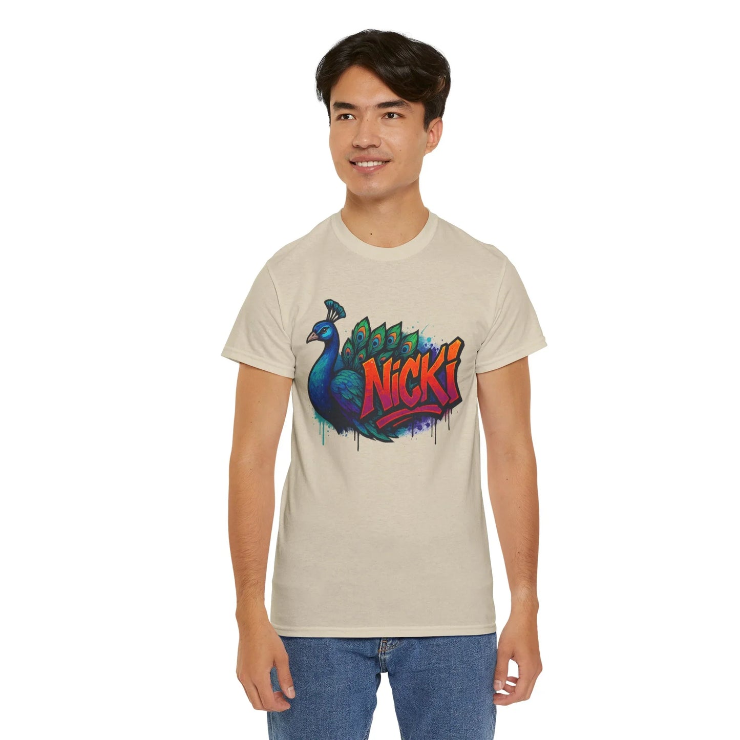 Man in beige t-shirt with colorful peacock and bold Nicki graffiti design