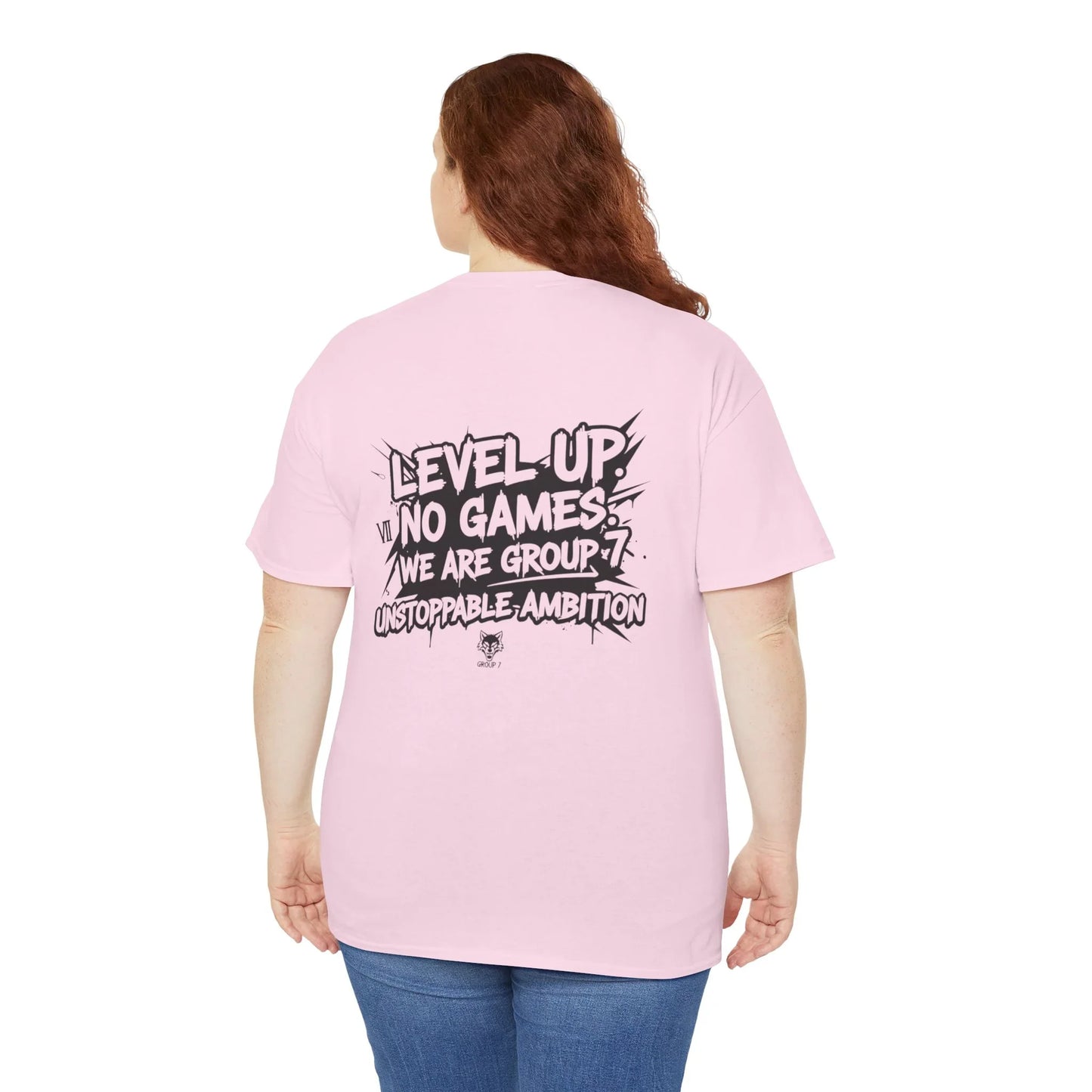 Woman wearing a pink t-shirt with 'Level Up. No Games. We Are Group 7. Unstoppable Ambition' slogan