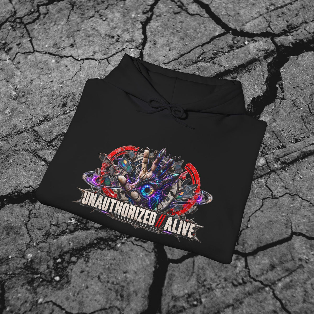Folded black cyberpunk graphic hoodie showing the vivid front artwork and heavyweight fabric against a concrete background