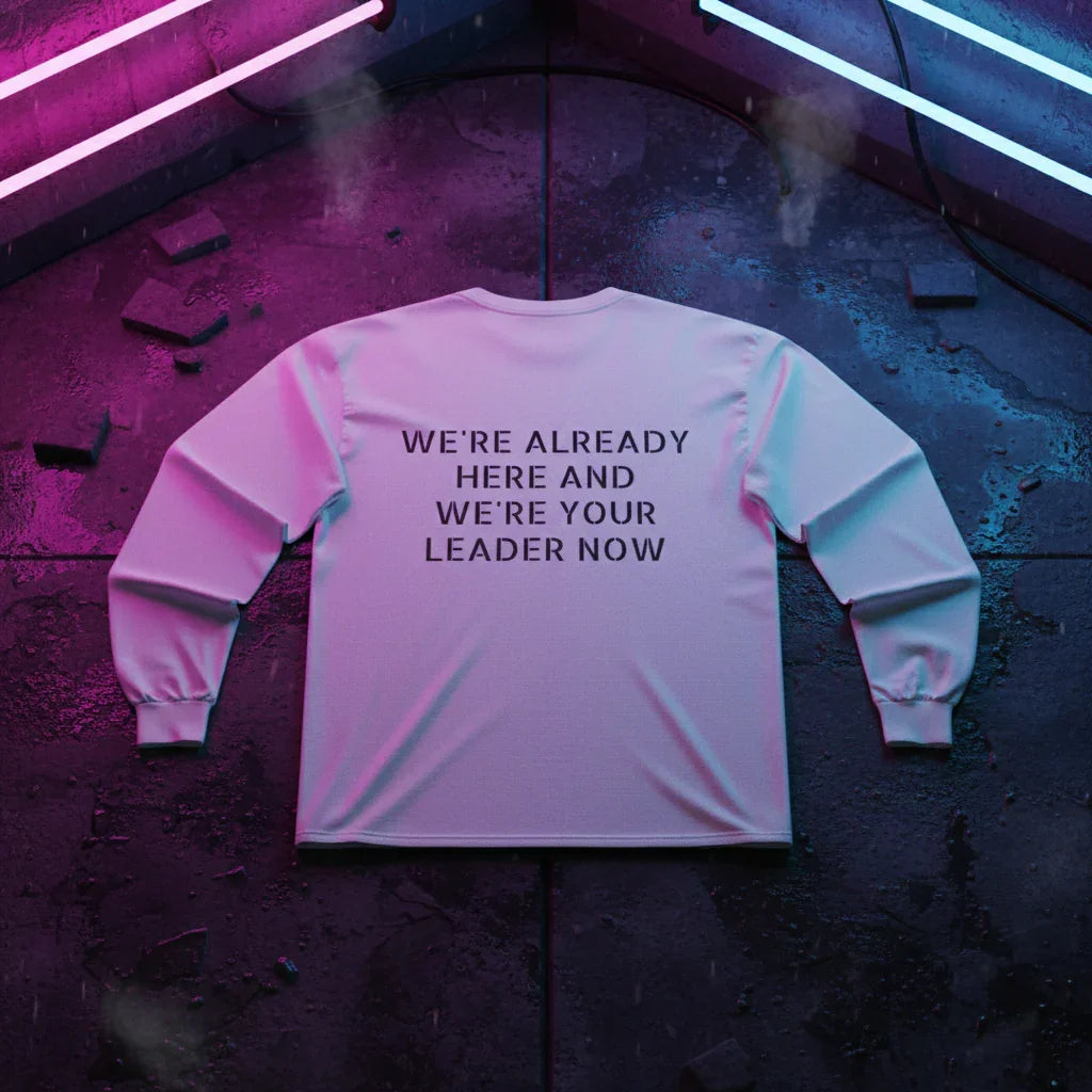 White sweatshirt with 'WE'RE ALREADY HERE AND WE'RE YOUR LEADER NOW' text, neon lights background