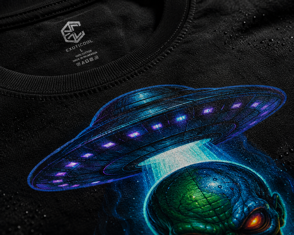 Close-up of the alien signal graphic tee showing a green alien, UFO and Exoticool neck label.
