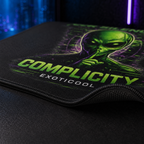 Close-up of the alien mouse pad showing the printed fabric surface, stitched edge and non-slip rubber backing.

