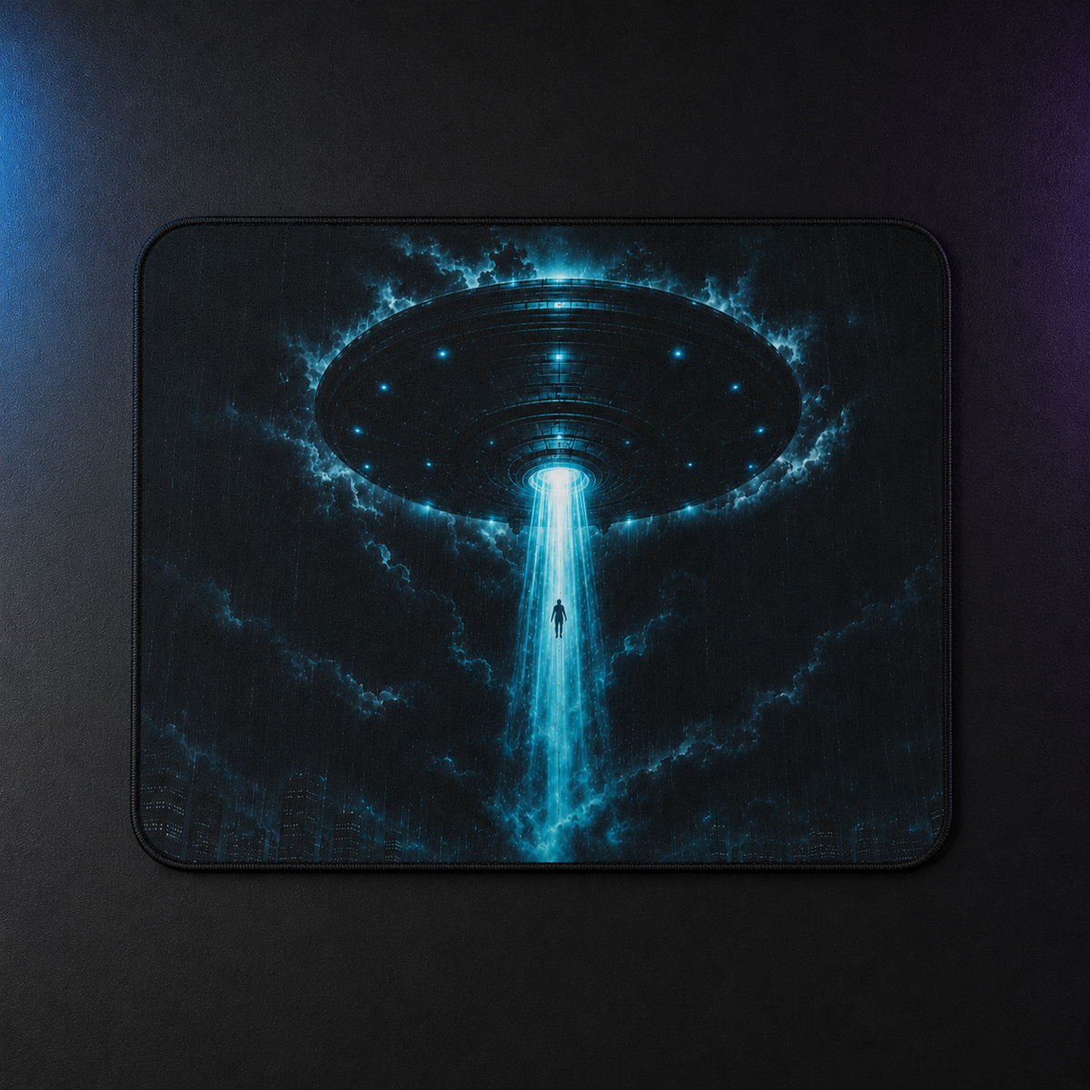 Overhead view of the rectangular UFO mouse pad showing a cyan beam lifting a figure through storm clouds.

