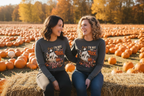 Two adult models wearing I’m Not the Trick I Am the Treat Halloween long sleeve shirts at a fall pumpkin patch