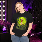 Model wearing the black Deseraè Stephens Janaè Neon Majesty Portrait Tee in a glamorous purple-lit dressing room