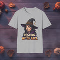 Resting Witch Face Halloween graphic tee in sport gray, front view on dark wood background