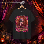 Jessica St. James black heavy cotton graphic tee hanging against a glamorous stage-inspired background