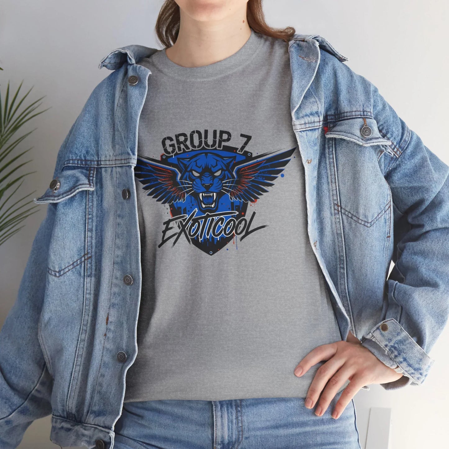Woman in denim jacket wearing gray t-shirt with Group 7 Exoticool panther wing logo