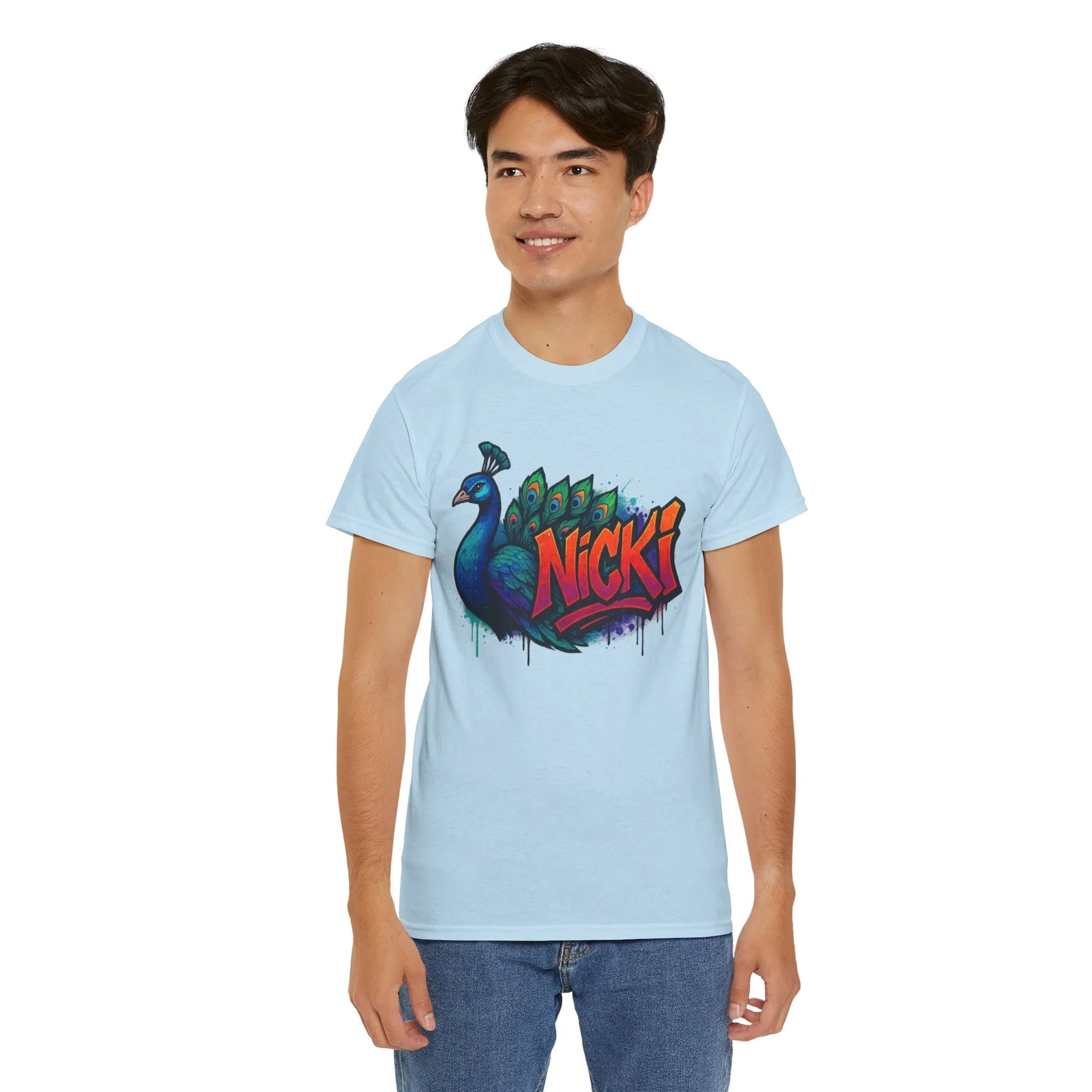 Man wearing light blue graphic t-shirt with colorful peacock and Nicki text design