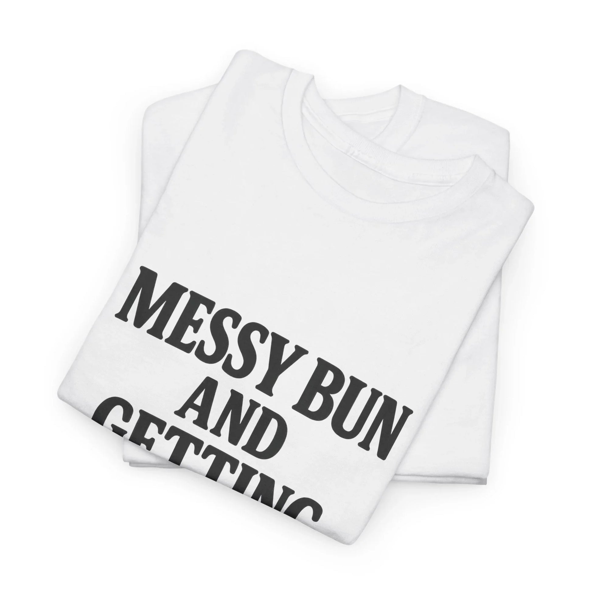 Folded white graphic t-shirt with bold black text reading 'MESSY BUN AND GETTING'