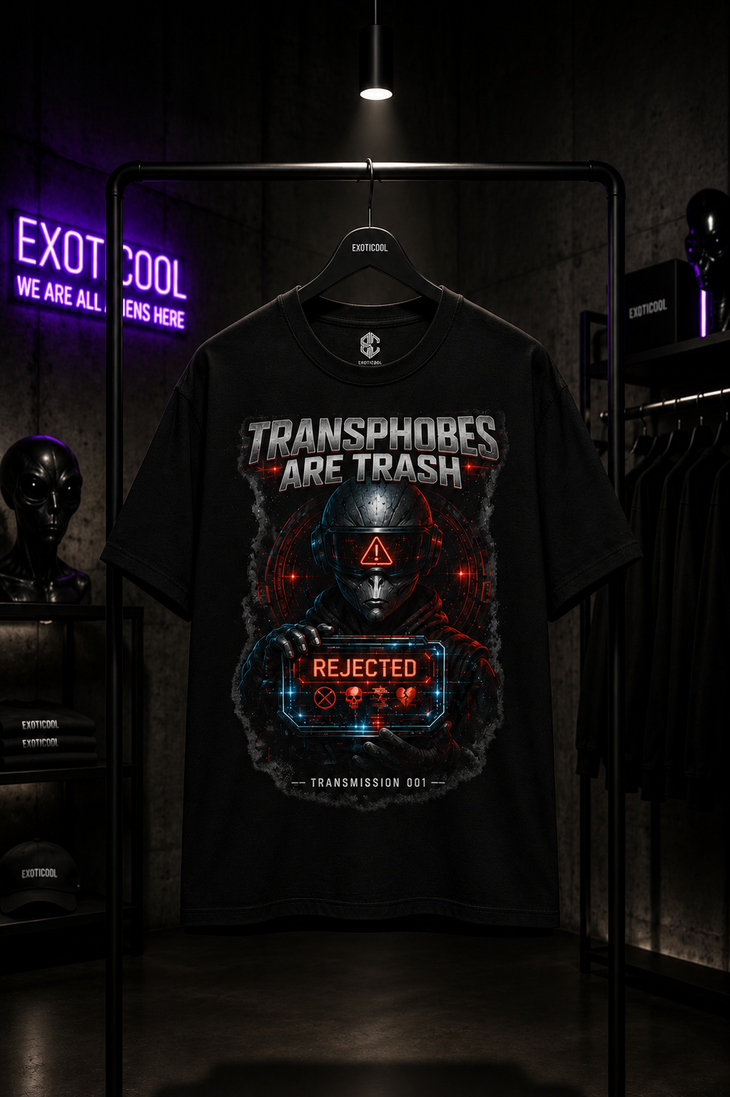 Exoticool Transphobes Are Trash alien streetwear graphic t-shirt displayed on a matte black hanger inside a luxury boutique with industrial concrete walls and cinematic lighting.