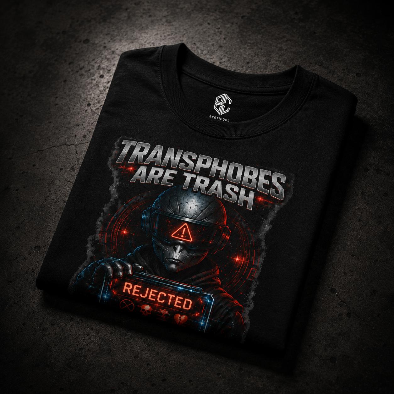 Folded Exoticool Transphobes Are Trash premium graphic t-shirt on a matte black surface showcasing alien streetwear design with luxury retail styling.