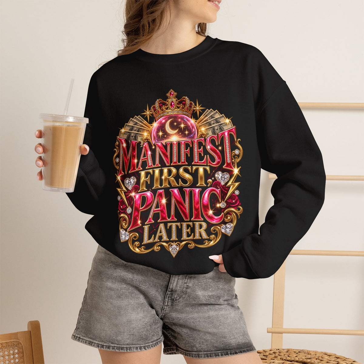 Woman wearing the Manifest First, Panic Later black crewneck sweatshirt in a casual lifestyle setting