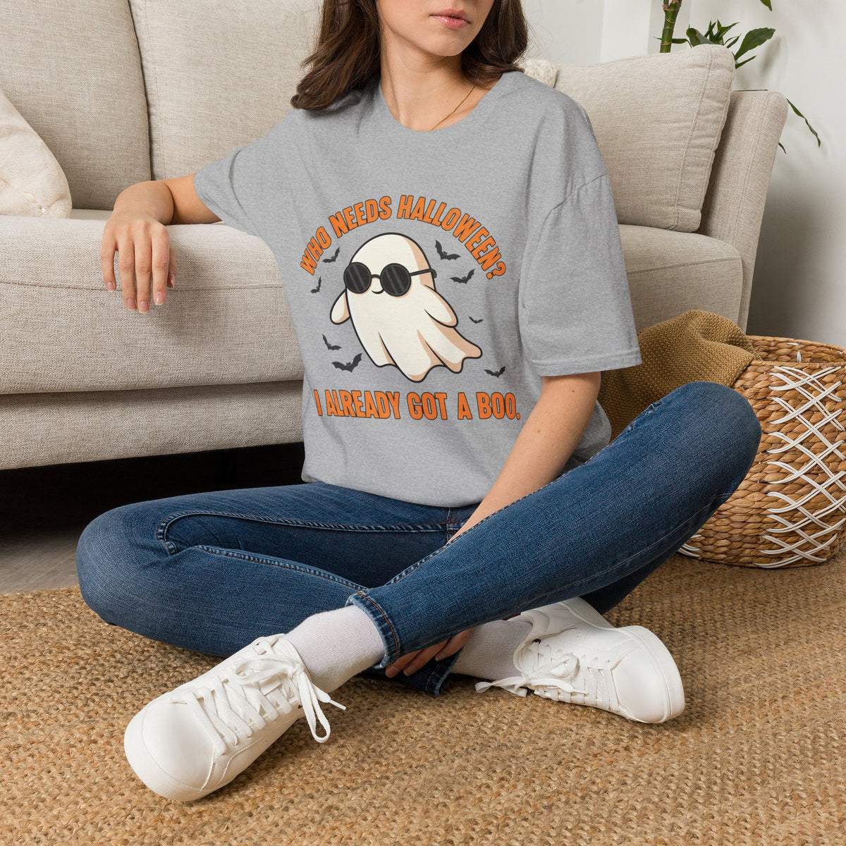 Seated model wearing the Who Needs Halloween? I Already Got a Boo tee in sport gray