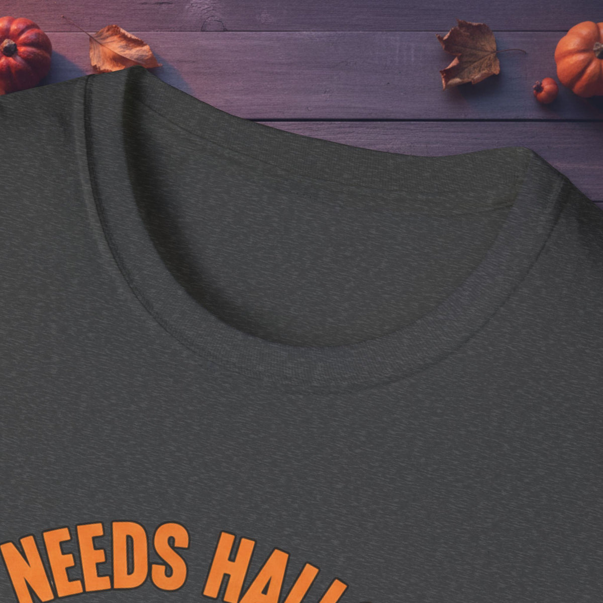 Close-up of neckline and front print on the Who Needs Halloween? tee in black
