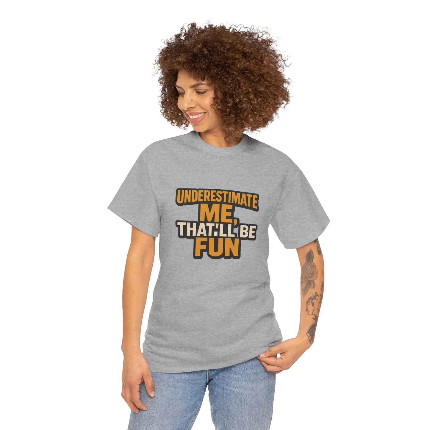 Woman in gray graphic t-shirt with 'Underestimate me, that'll be fun' text, casual style
