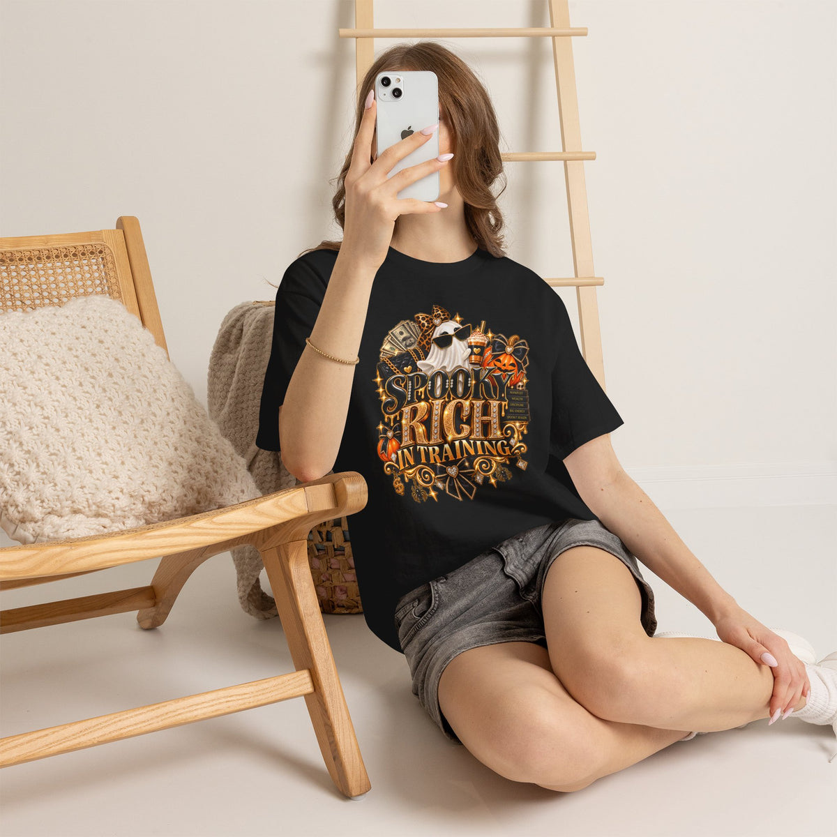 Woman wearing the Spooky Rich in Training black graphic tee in a casual lifestyle setting