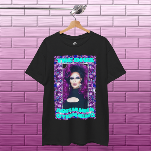Black Adrianna Stephens Purple Reign Diva graphic T-shirt hanging against a textured concrete background