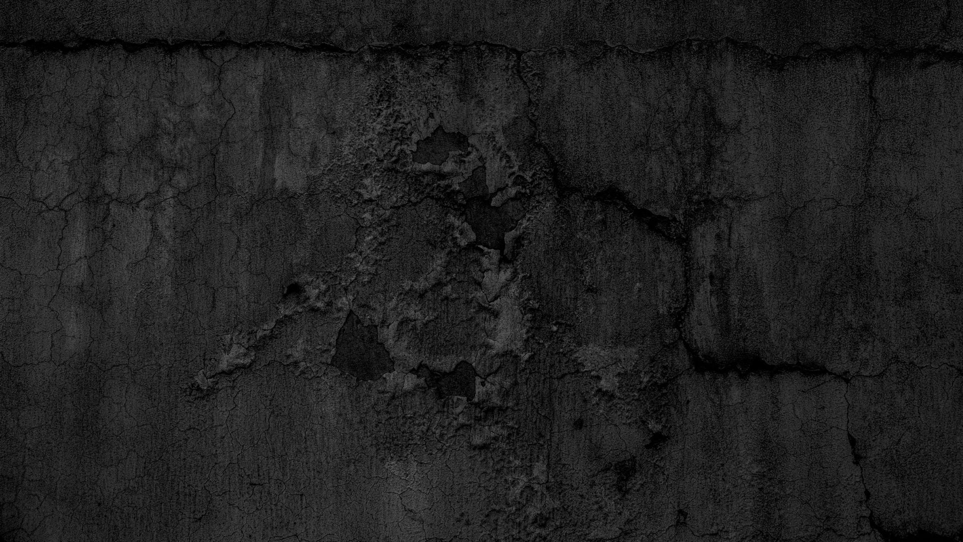 Dark textured background with a distressed concrete or plaster surface showing cracks, peeling texture, and uneven charcoal tones.