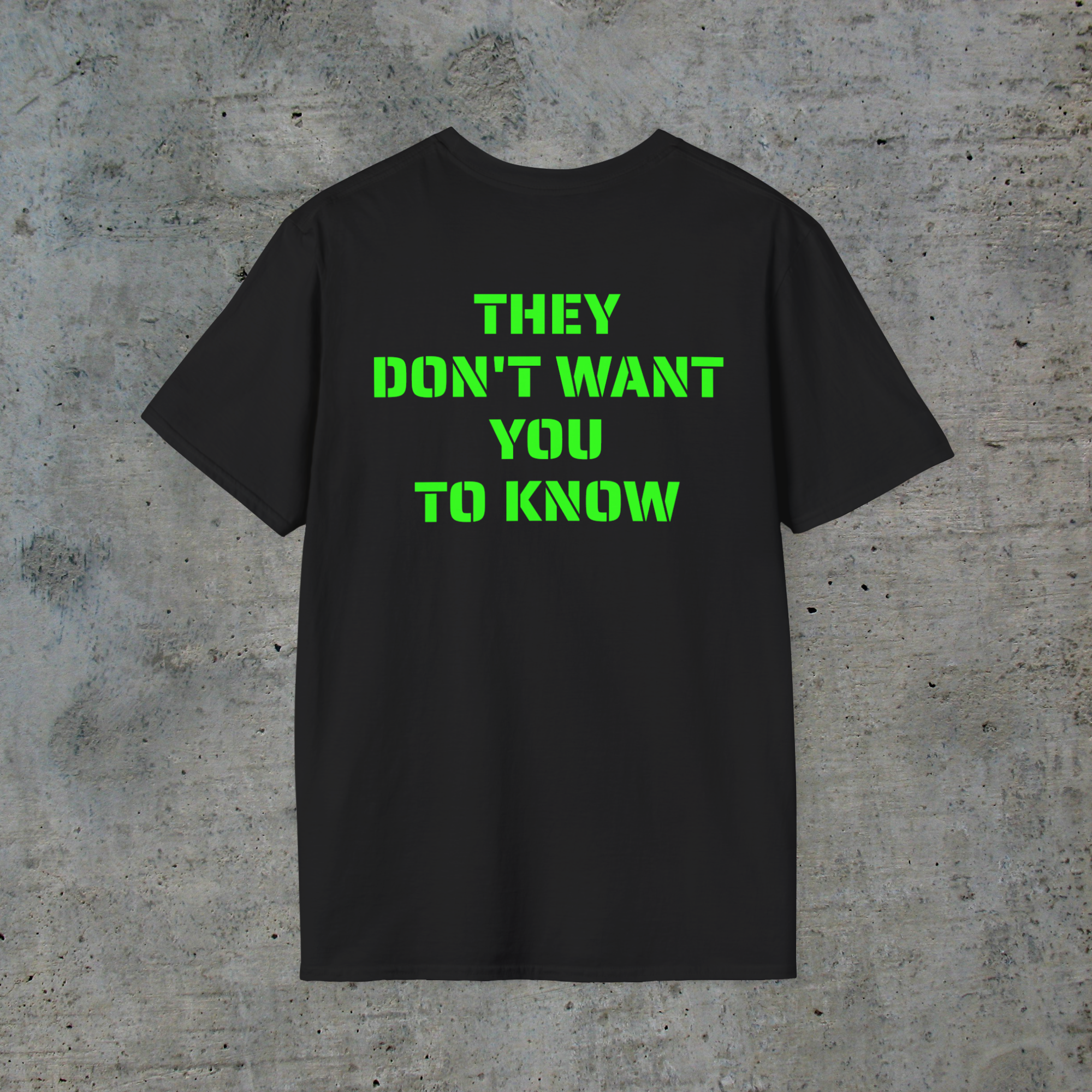 Back of black alien signal graphic tee reading They Don’t Want You to Know in neon-green lettering