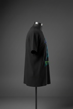 Left side view of black Exoticool Alien Signal Tee on mannequin showing fit and front alien graphic placement