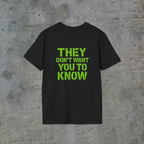 Back of black alien signal graphic tee reading They Don’t Want You to Know in neon-green lettering