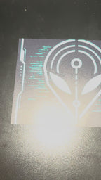 Video showing the artwork and printed details of the We Are All Aliens Here bumper sticker