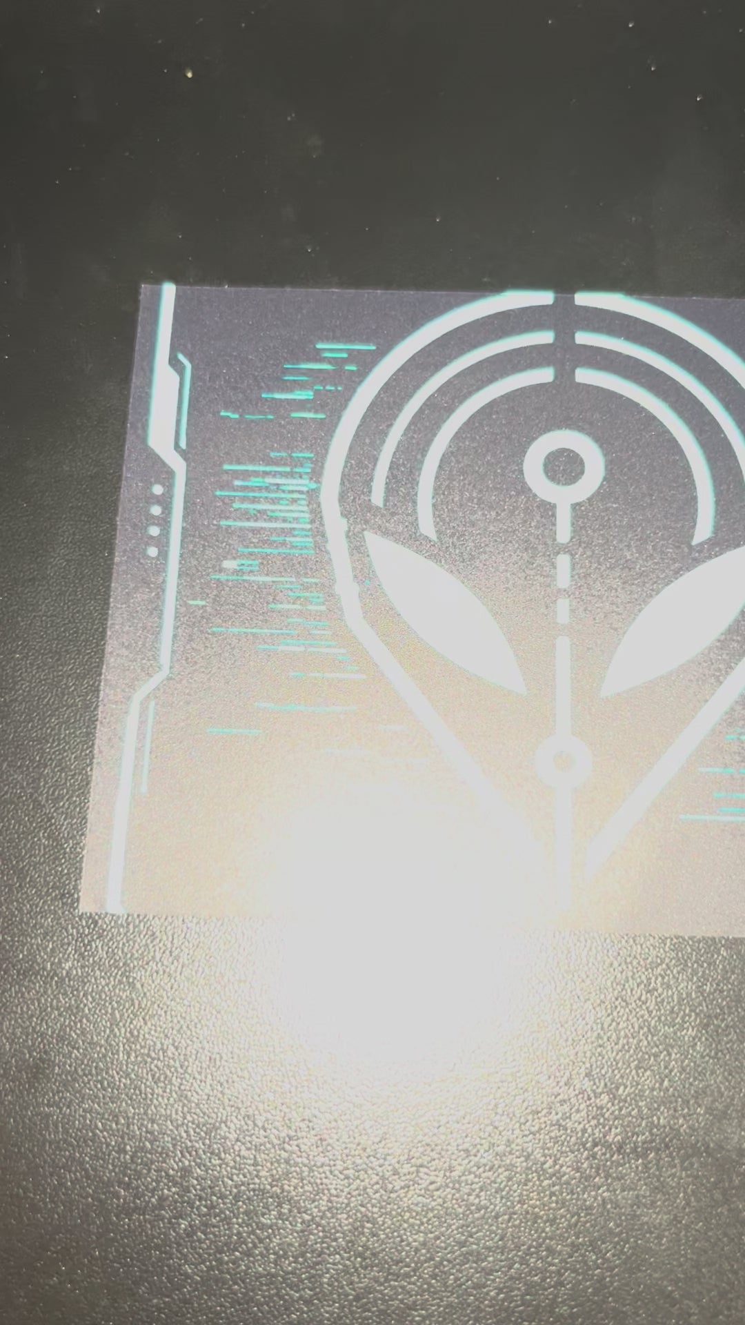 Video showing the artwork and printed details of the We Are All Aliens Here bumper sticker