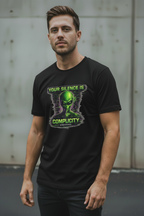 Male model wearing black Exoticool Your Silence Is Complicity T-shirt with bold front statement graphic in an urban setting