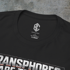 Close-up of the Exoticool printed neck label and collar on the black trans rights graphic tee