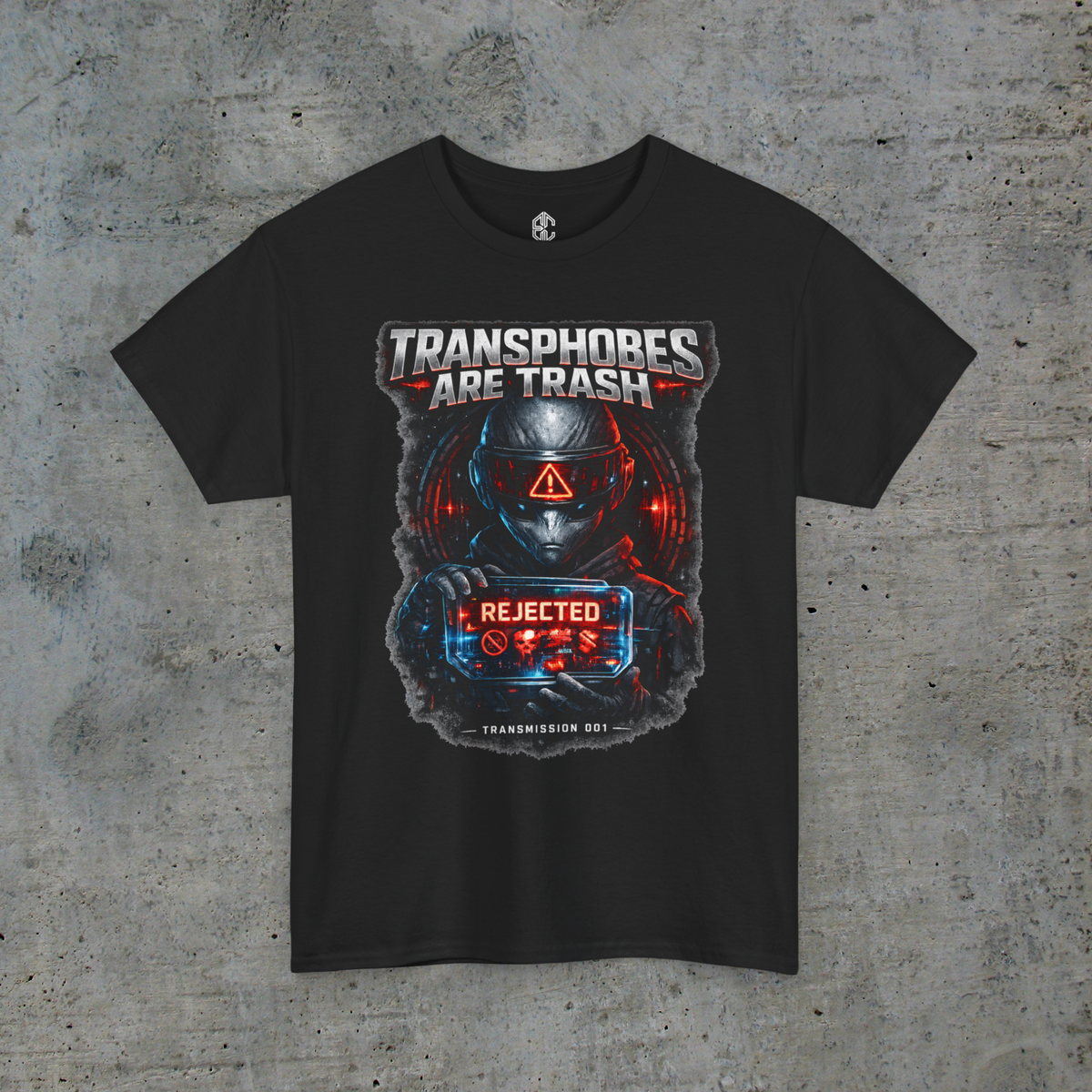Front view of black Transphobes Are Trash trans rights graphic tee on a light-gray concrete background
